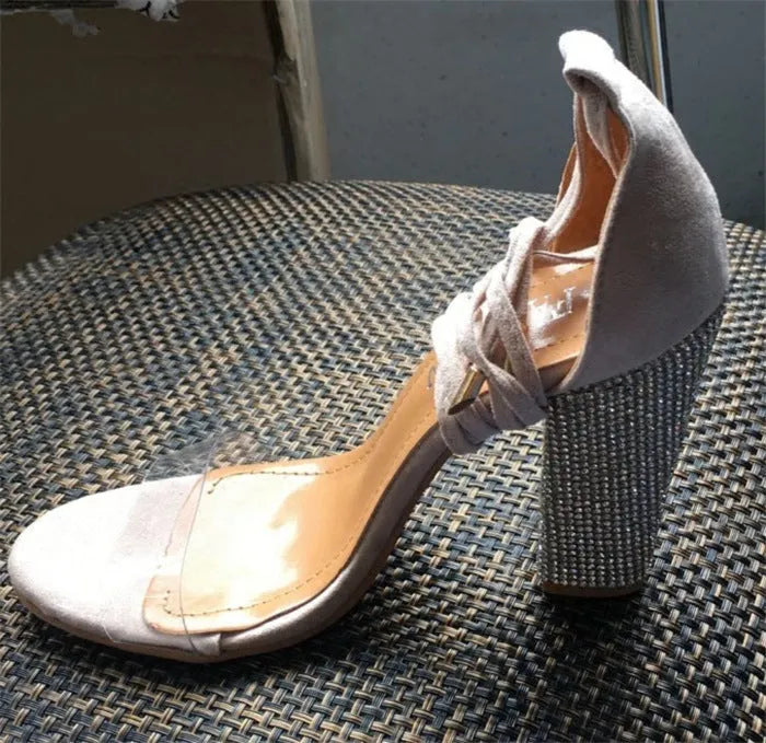 Black or gold plastic pointed-toe high heel shoes on white background