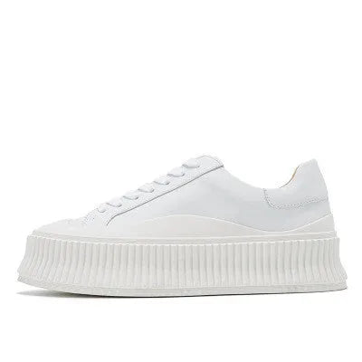 Women's white and black chunky platform shoes with back lacing and a thick rubber sole.