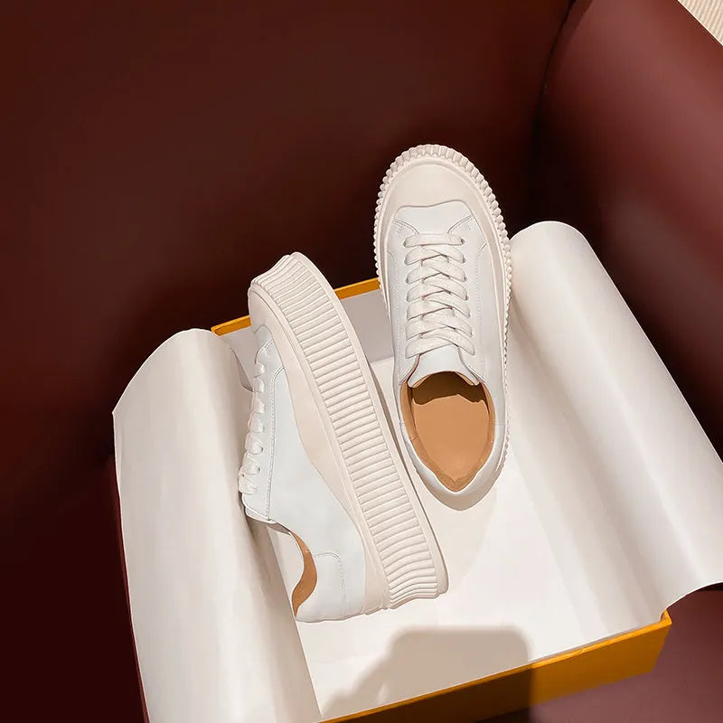 Women's white and black chunky platform shoes with back lacing and a thick rubber sole.