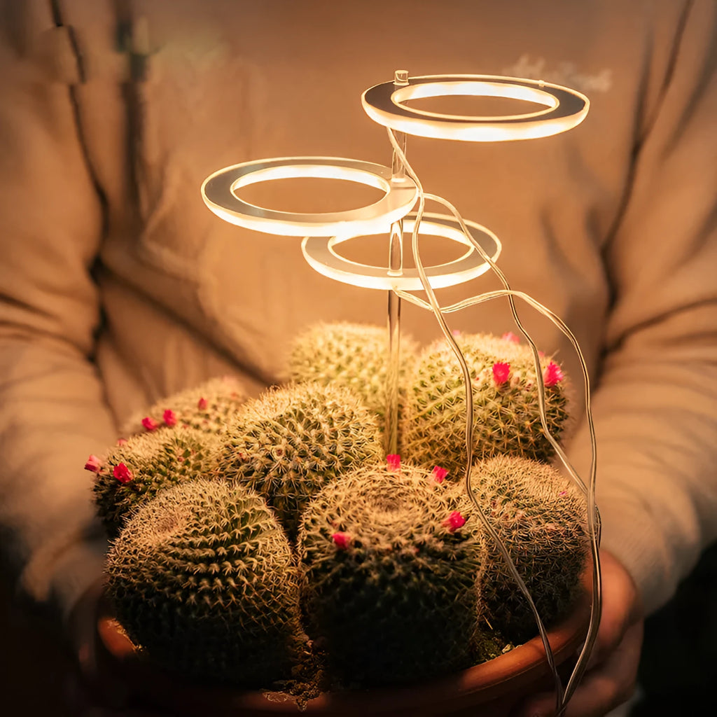 USB LED plant grow light with transparent yellow housing and acrylic mounting stick.