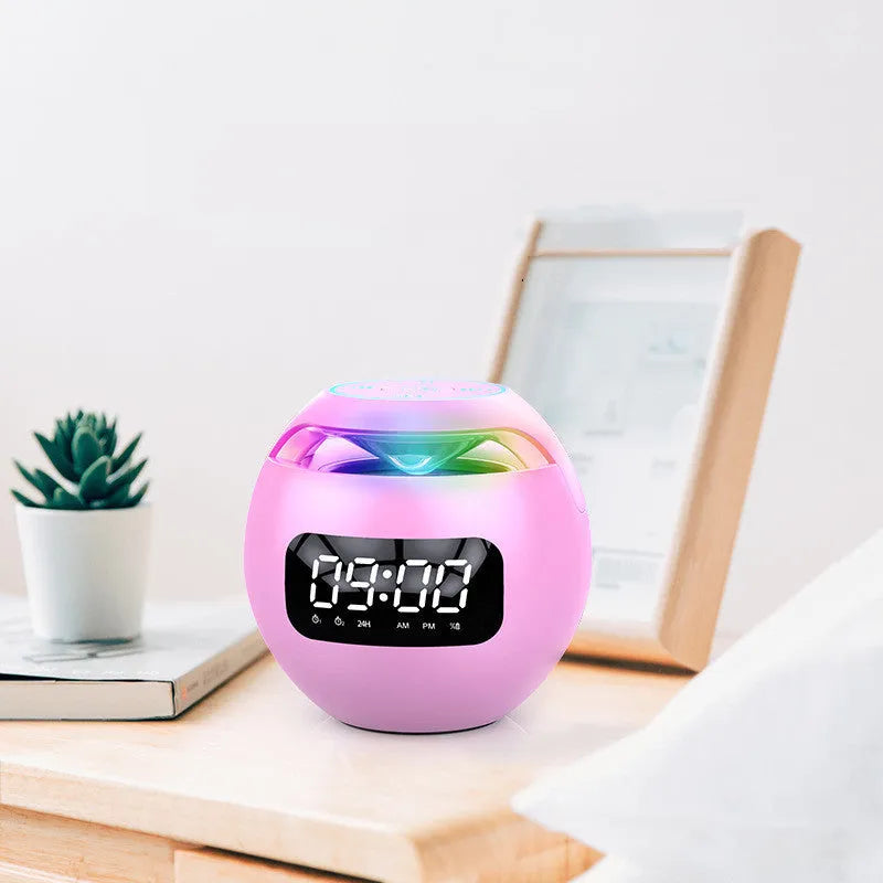 Mini ball Bluetooth speaker in pink with colourful lights and clock display on plastic casing