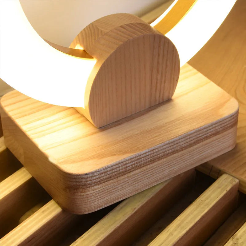 Round wooden art chandelier with acrylic shade hanging in a living room, available in 20cm and 30cm sizes.