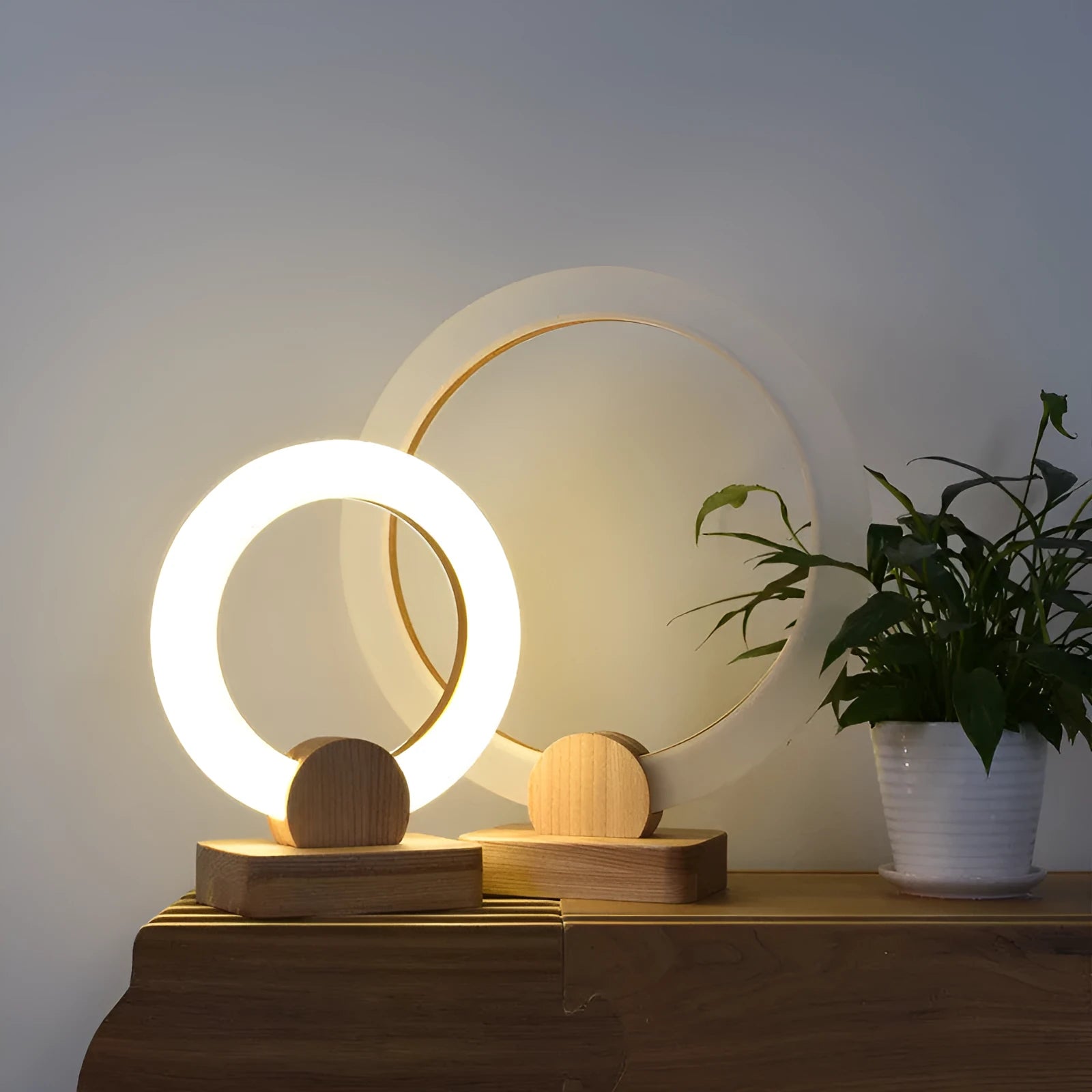 Round wooden art chandelier with acrylic shade hanging in a living room, available in 20cm and 30cm sizes.