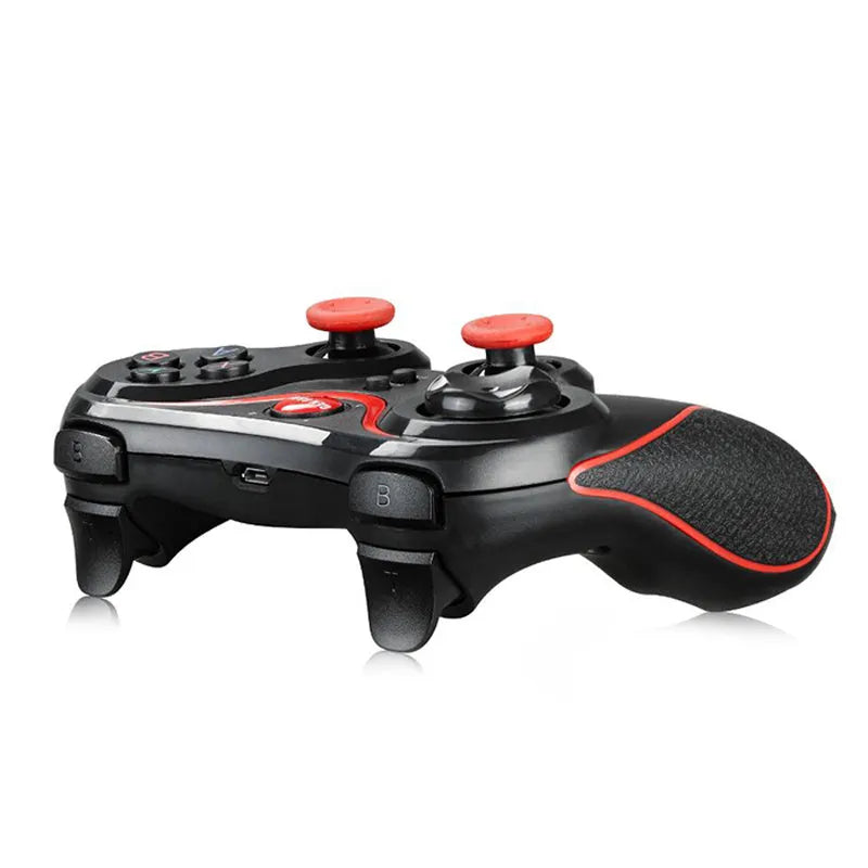 Black wireless Bluetooth gamepad controller for Android and iOS mobile phones on a table.
