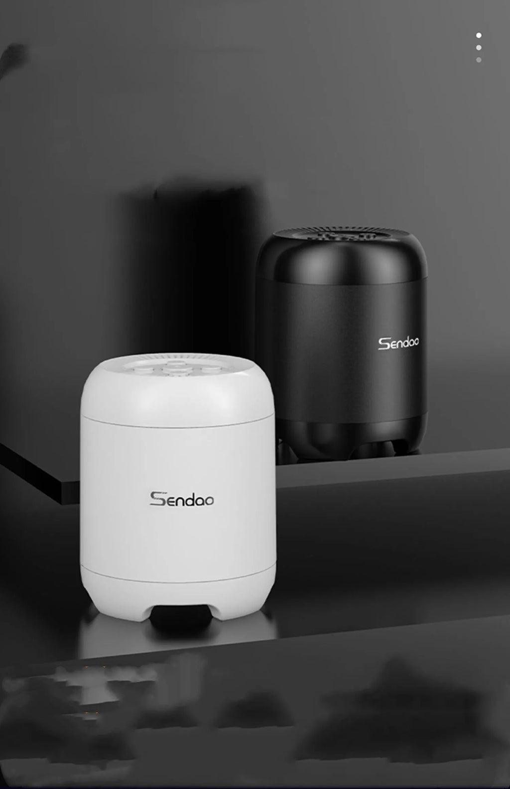 Small black or white portable Bluetooth speaker with a subwoofer, showing compact size.
