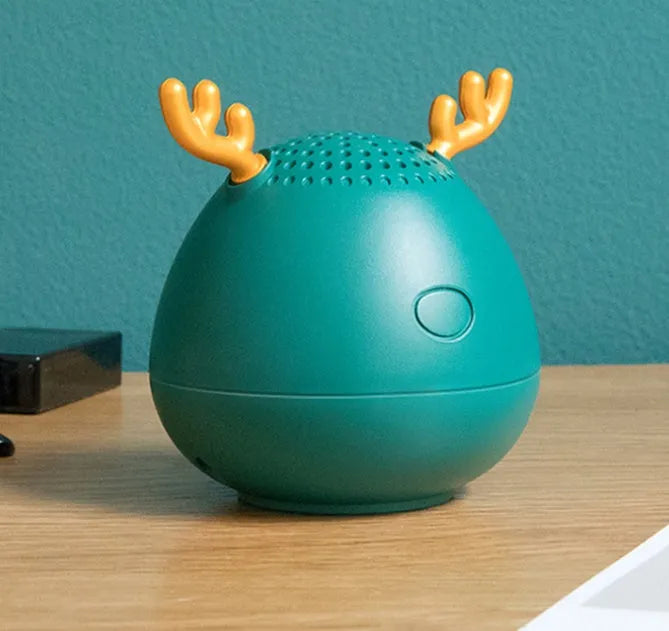 Small rectangular portable Bluetooth speaker in green, pink, or white with USB charging cable.
