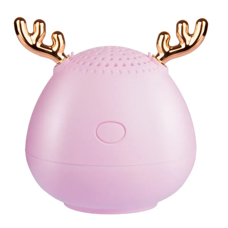 Small rectangular portable Bluetooth speaker in green, pink, or white with USB charging cable.