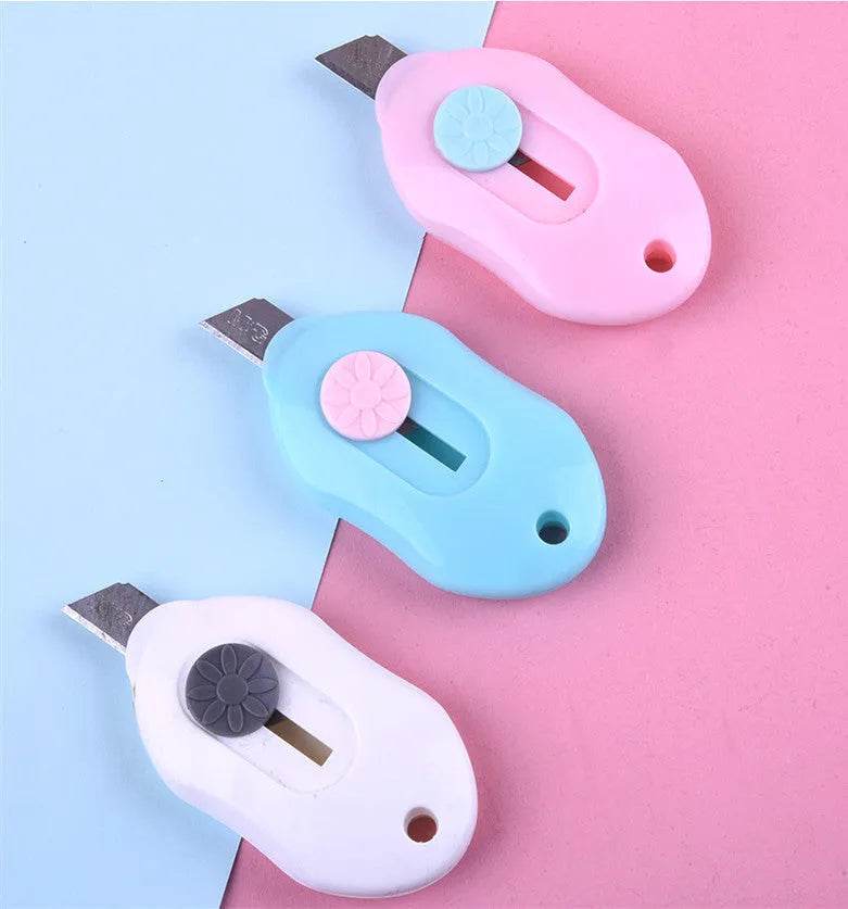 Cartoon art knife with open box design showing plastic and metal construction