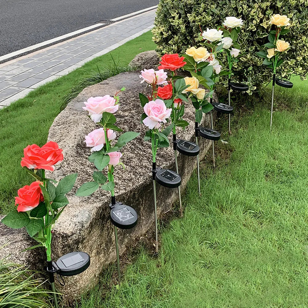 Three-headed solar rose garden lamp with white LED lights, standing 80cm tall with pink silk cloth petals on stainless steel stem
