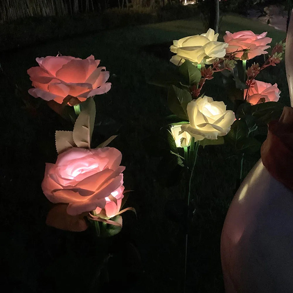 Three-headed solar rose garden lamp with white LED lights, standing 80cm tall with pink silk cloth petals on stainless steel stem