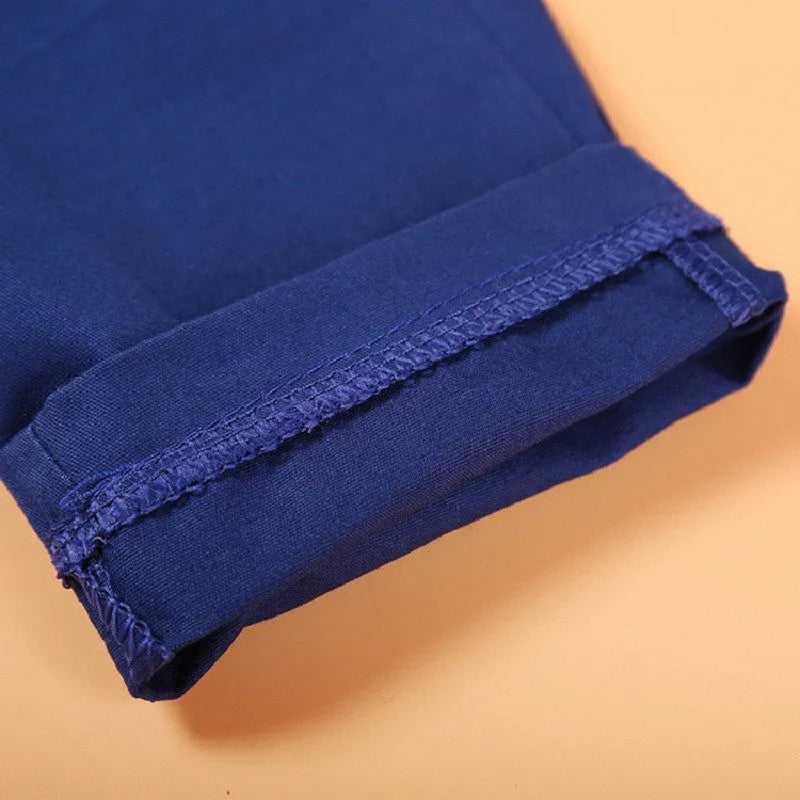 Boys blue casual suit set with vest, turtleneck, trousers, and tie on a hanger
