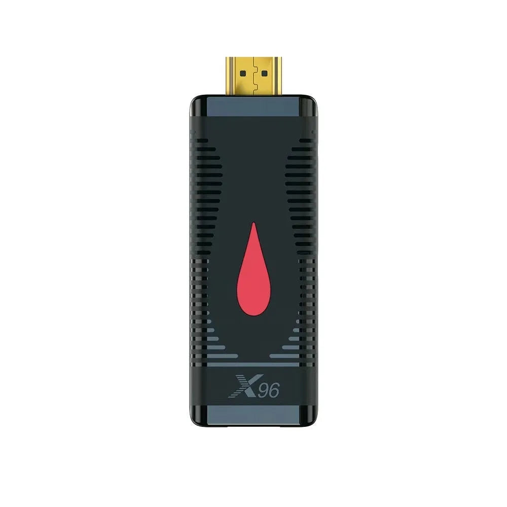 Android smart TV set-top box dongle with remote and cables on a wooden surface.