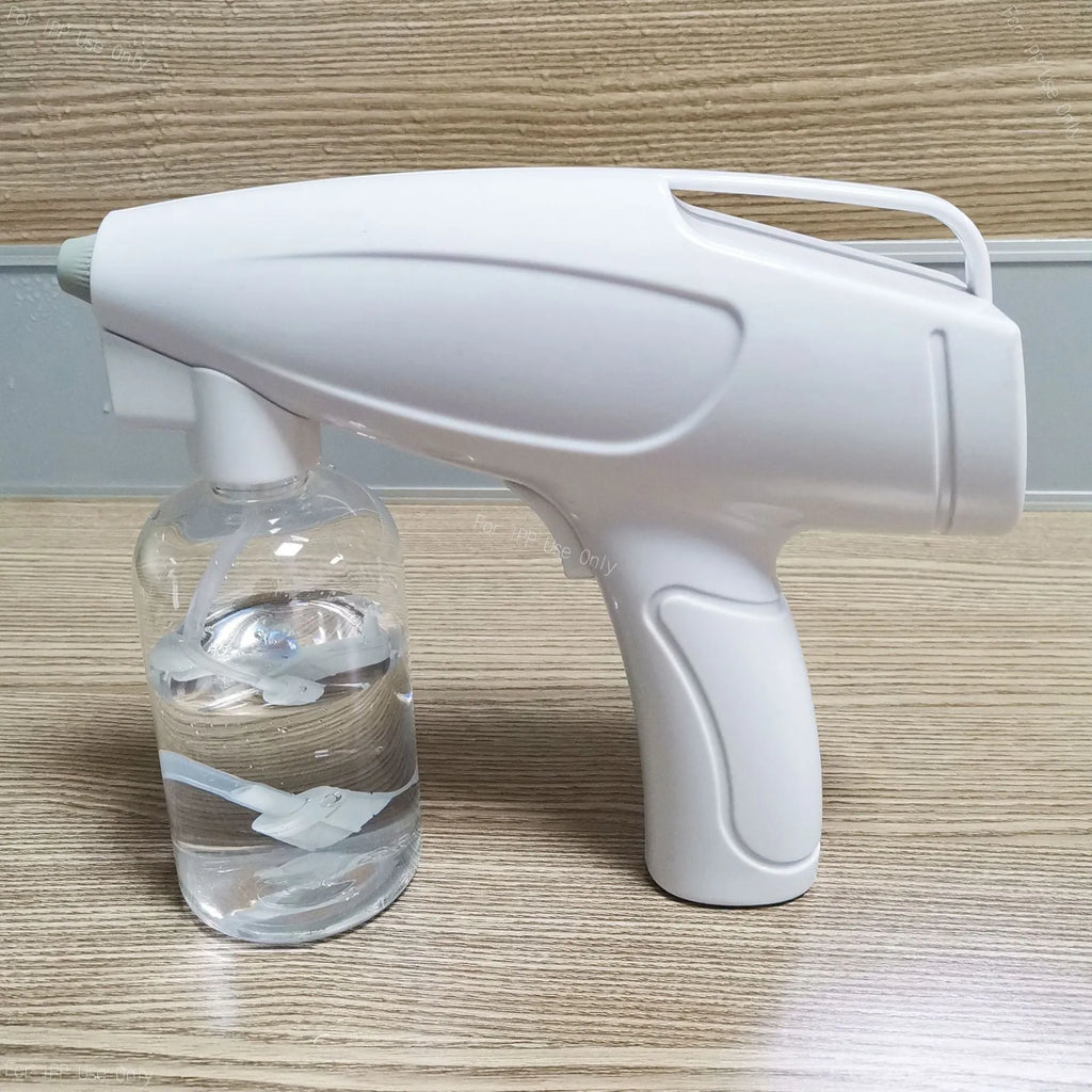 White handheld cordless electric spray gun with USB-C charging port on display