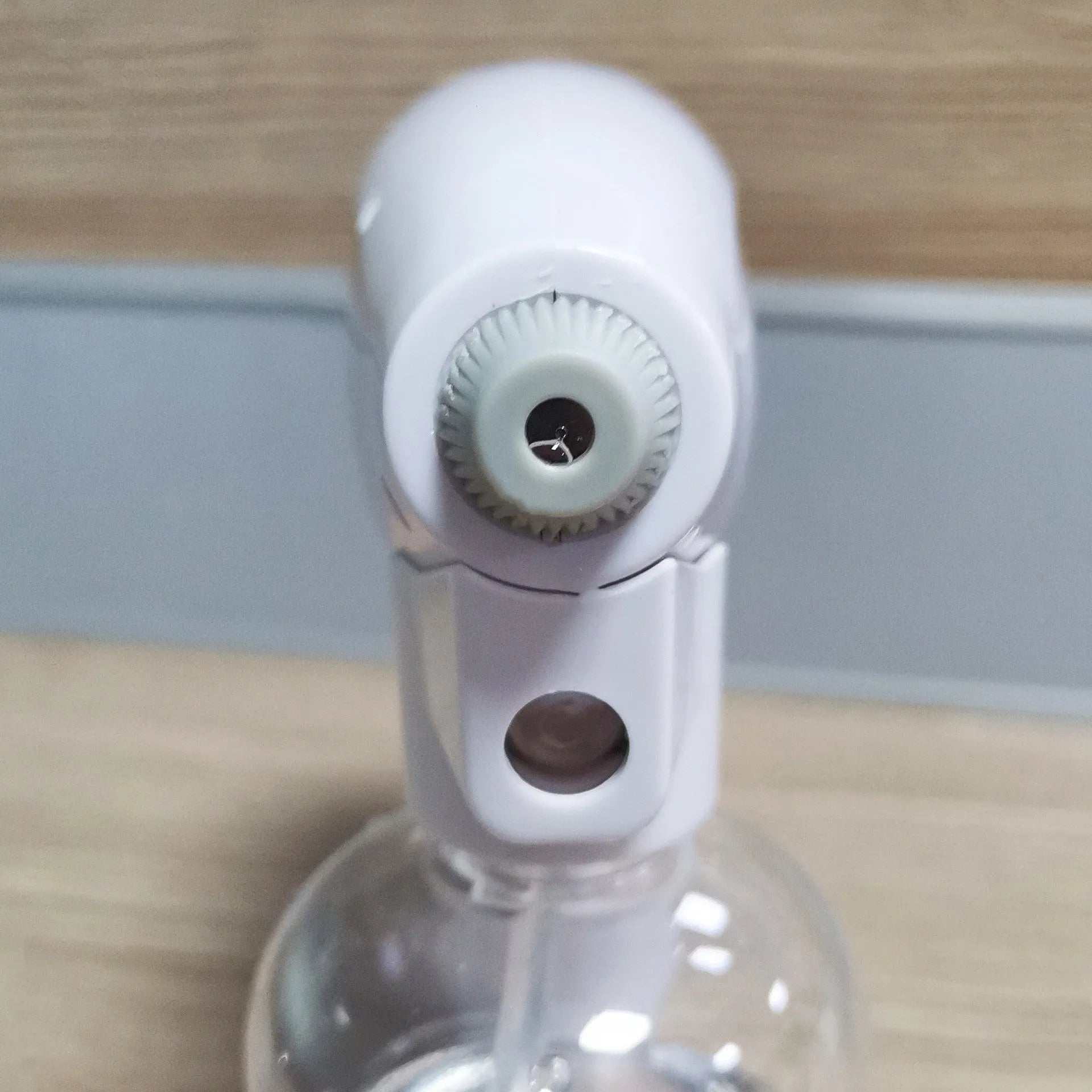 White handheld cordless electric spray gun with USB-C charging port on display