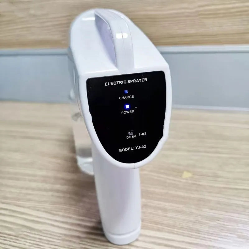 White handheld cordless electric spray gun with USB-C charging port on display