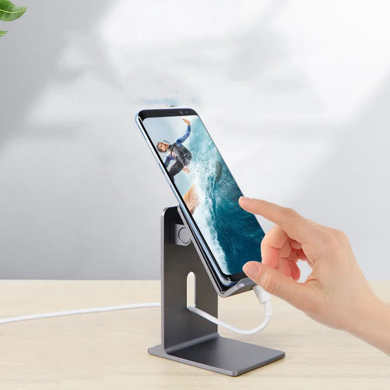 Alloy mobile phone holder bracket on desktop in dark space gray colour holding smartphone