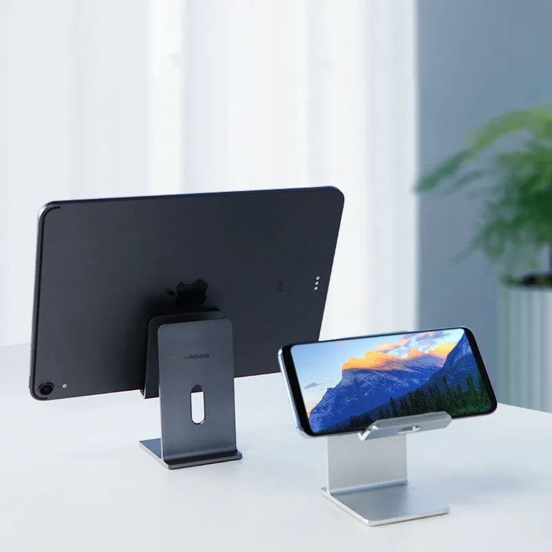 Alloy mobile phone holder bracket on desktop in dark space gray colour holding smartphone
