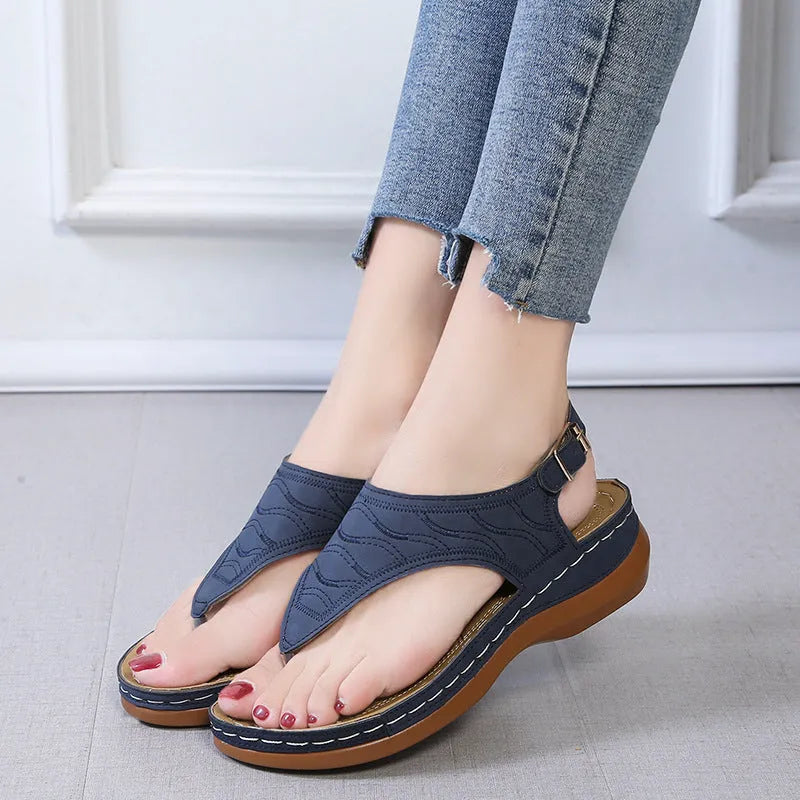 Women's casual wedge-heel sandals with adjustable buckle strap in a solid colour.