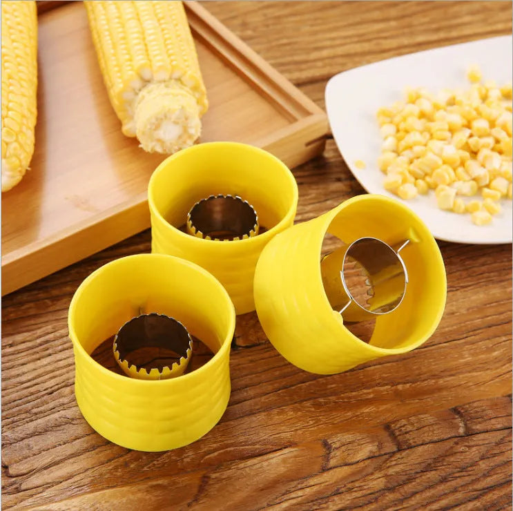 Yellow manual corn grinder thresher with corn-shaped PP handle and stainless steel gear.