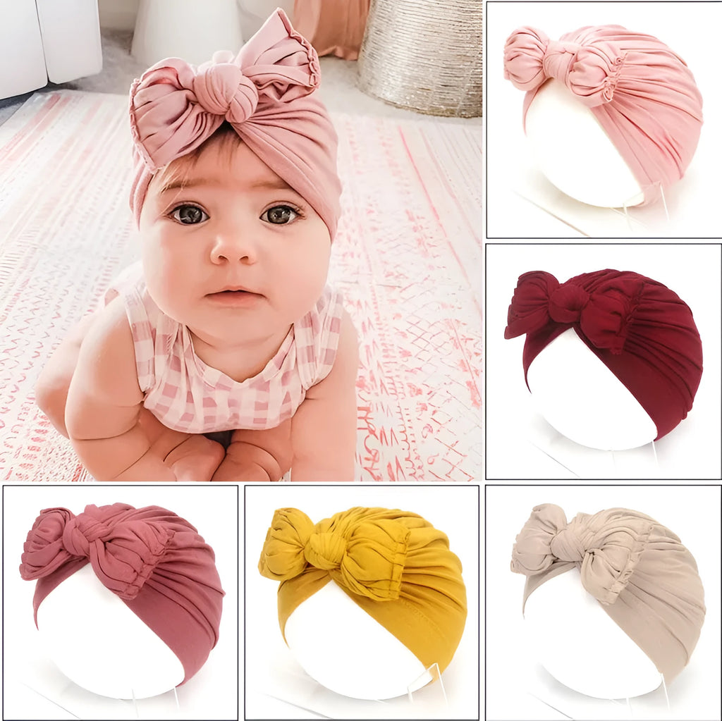 Soft knitted baby bonnet for newborns and toddlers in a solid colour on a mannequin head