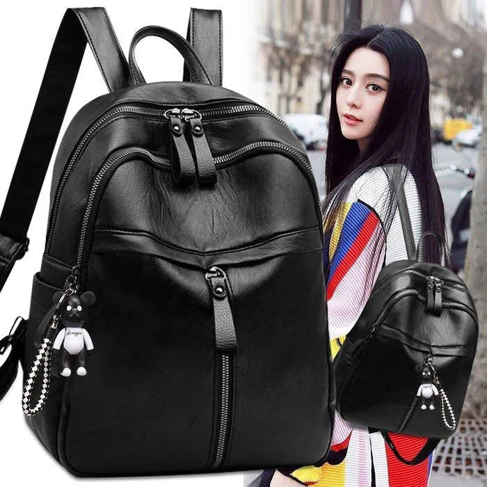 Black medium-size PU leather soft surface backpack with double straps and a zipper opening