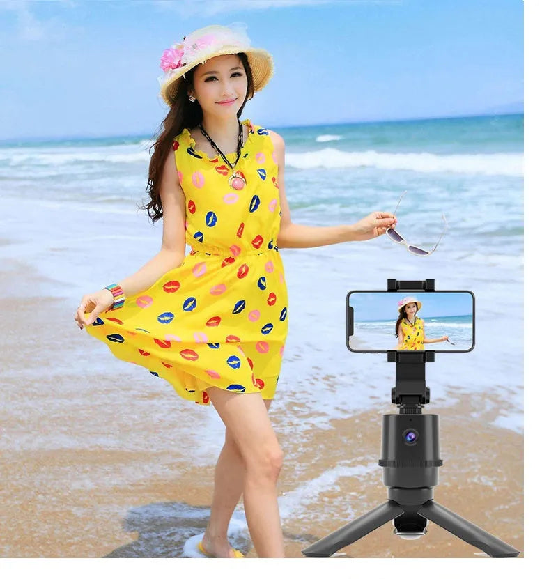 Intelligent AI tracking pan tilt camera bracket mounted on a selfie pole, holding a smartphone.