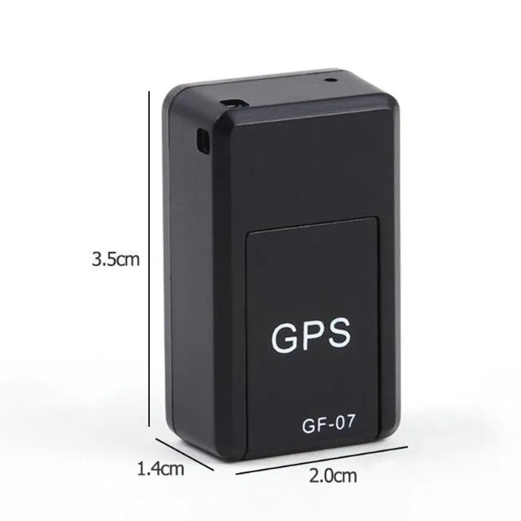 Black mini magnetic GPS tracker next to USB charging cable on a dark surface.