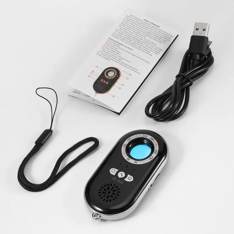 Compact black wireless anti-theft alarm detector for travel security with vibration sensor.