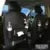 PU leather car seat back storage organiser with multiple pockets hanging on a car seat.