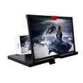 Black desktop mobile phone holder with magnifying glass enlarging a phone screen on a wooden table.