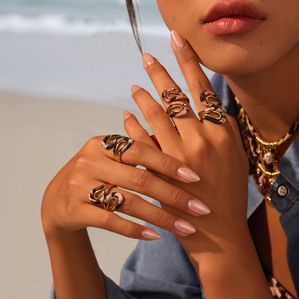 Stainless steel open mouth ring with leopard print and geometric heart or star shape design.