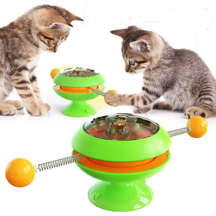 Rotatable plastic cat toy with catnip balls in a transparent top and a large suction cup base, shown in lake blue.