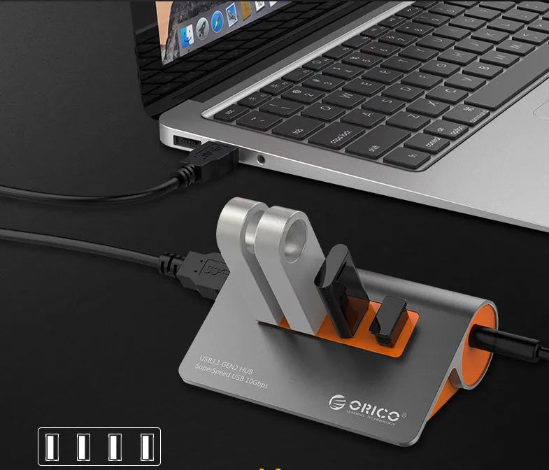 Dark grey and orange aluminium USB hub with 4 ports, separate power unit, and 100cm cable