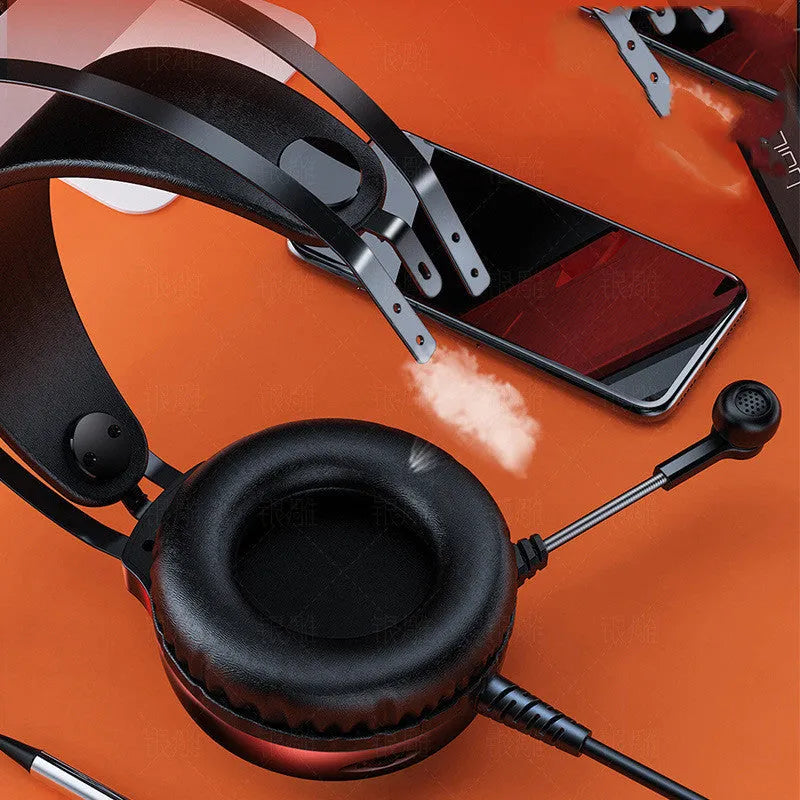 Black wired PC headset with microphone, large round earmuffs, and a long cable.