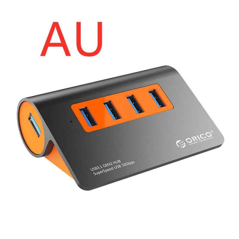 Dark grey and orange aluminium USB hub with 4 ports, separate power unit, and 100cm cable