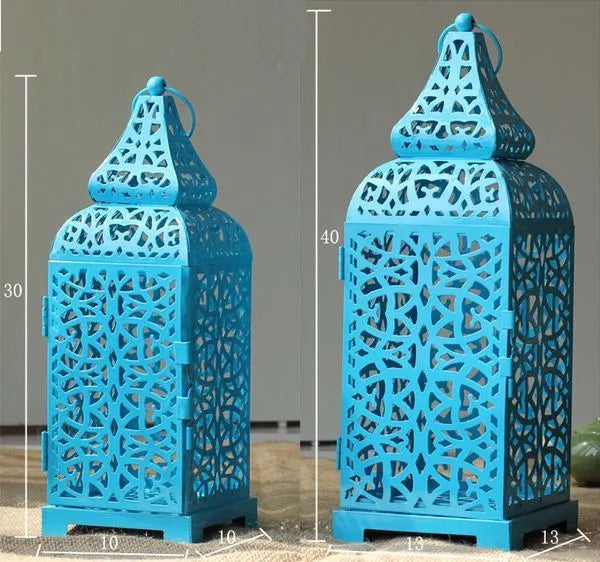 Blue geometric Moroccan iron lantern candlestick for tea lights on a table.