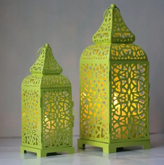 Blue geometric Moroccan iron lantern candlestick for tea lights on a table.