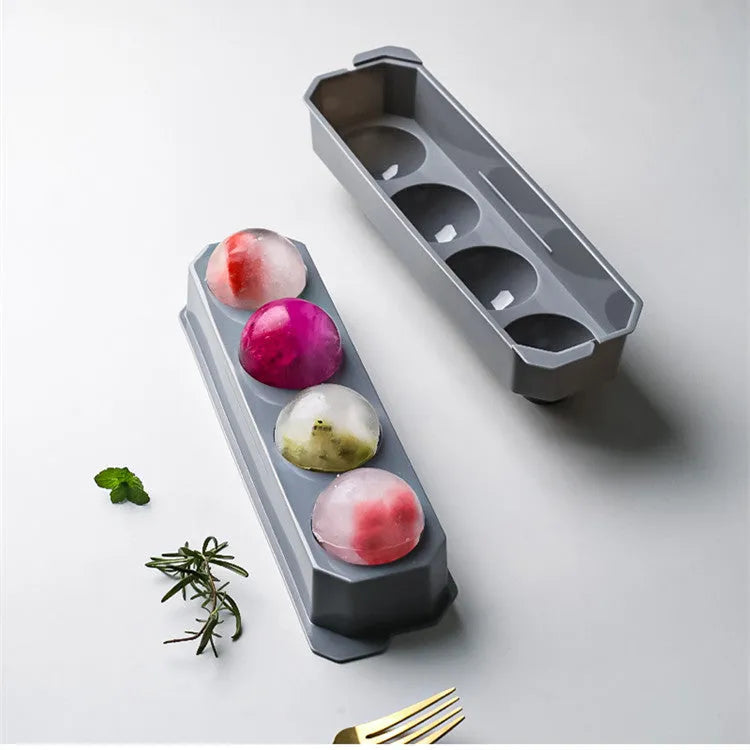 Silicone ice tray showing hockey puck, sphere, round and pentagon ice mould shapes in various colours