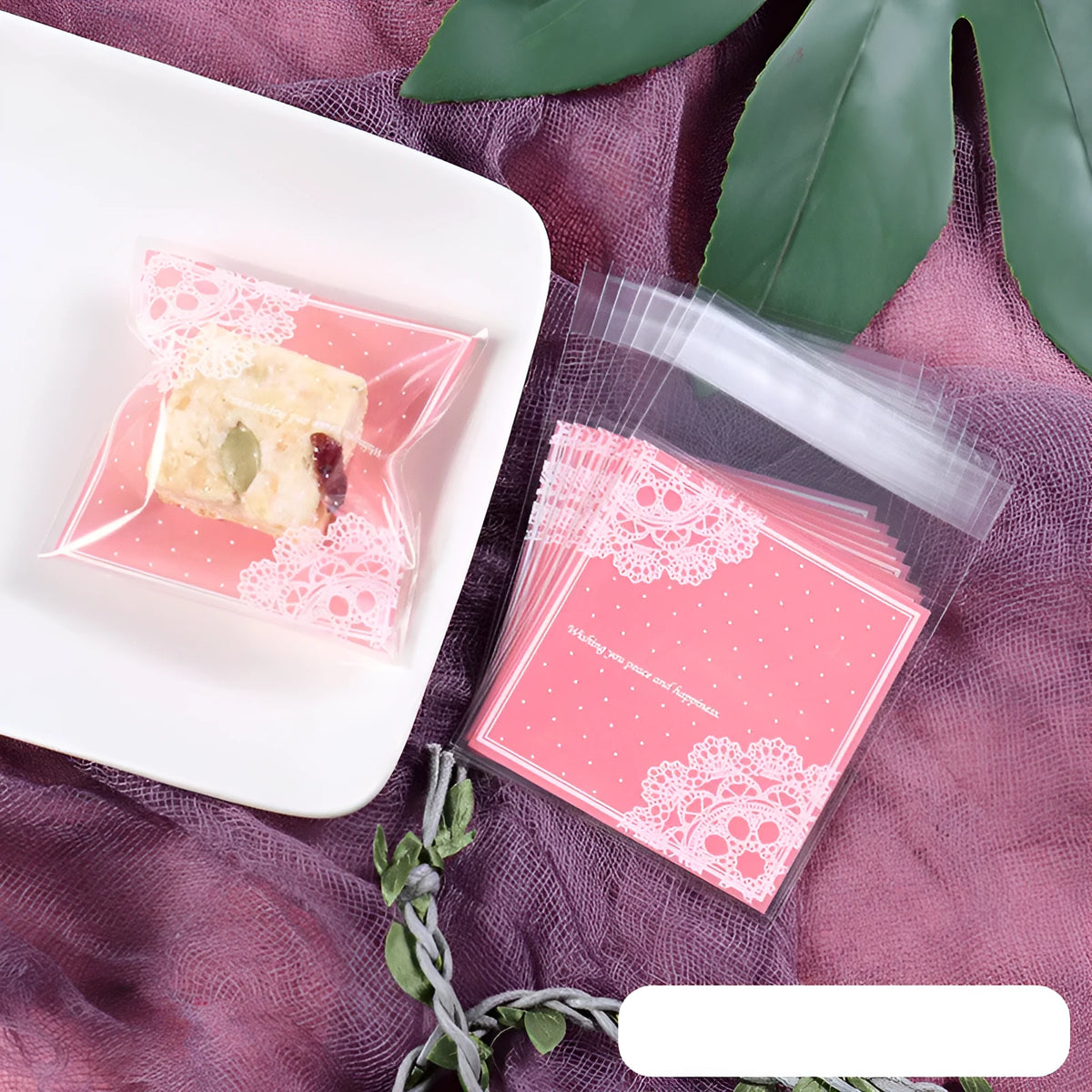 Pink self-adhesive plastic packaging bag with a 3cm flap, shown in a pack of 100.