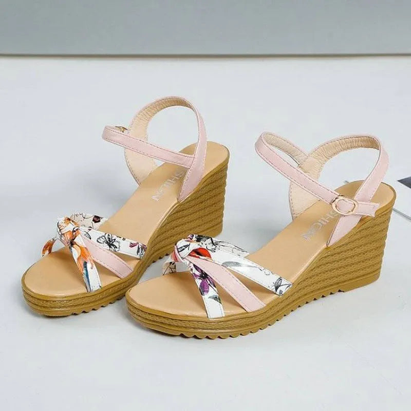 Women's pink wedge sandals with a thick heel, fish mouth design, and a one-shaped buckle.