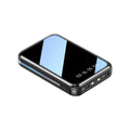 White digital display power bank showing battery percentage, with two USB output ports on a black plastic casing.