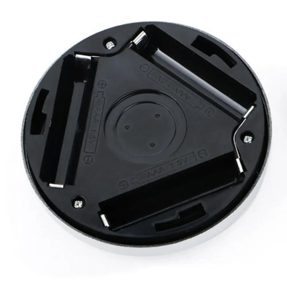Silver circular wireless motion sensor night light on a table showing its 80mm diameter.