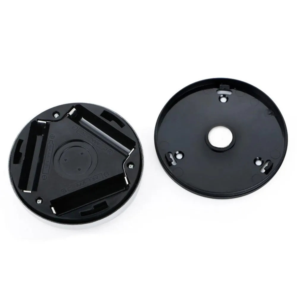 Silver circular wireless motion sensor night light on a table showing its 80mm diameter.