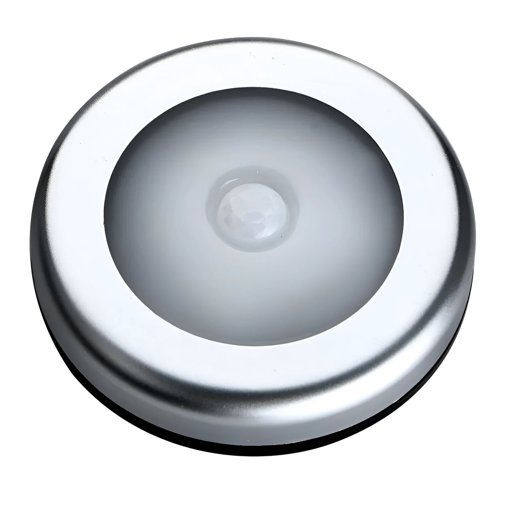 Silver circular wireless motion sensor night light on a table showing its 80mm diameter.