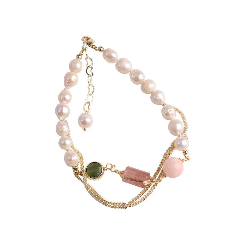 Women's freshwater pearl bracelet with strawberry crystal charm in geometric design on pink background