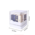 Pink press lift lipstick storage box with transparent lid on a desktop.