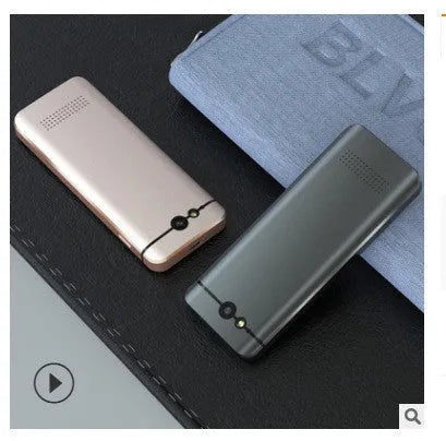 Small gold M9 electronic language translator for group chat and photo translation on a table.