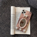 Brown marble pattern iPhone case with a rhinestone bowknot and mirrored back.