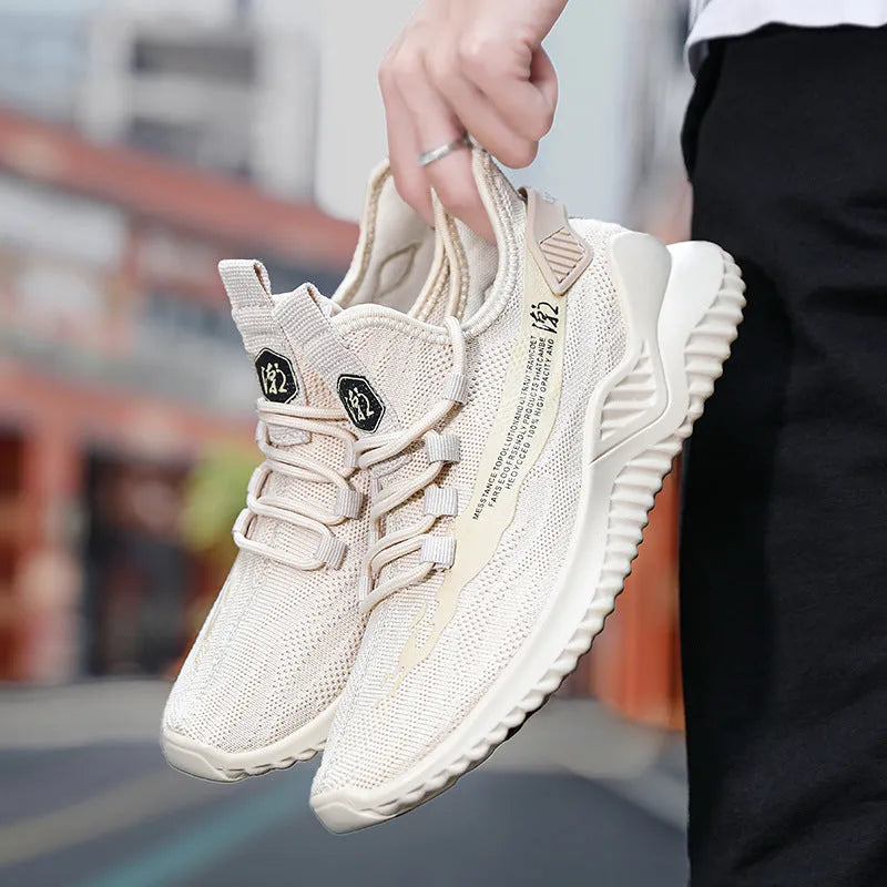 Men's white low-top mesh sports sneakers with rubber sole on a plain background