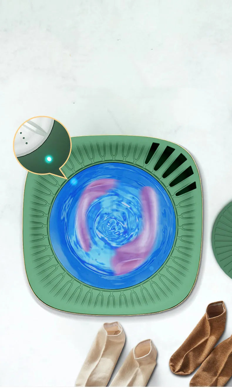 Green and white mini portable washing machine for underwear and socks on a countertop.
